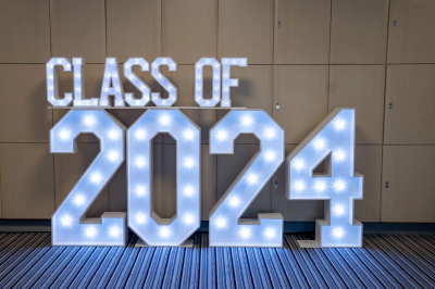 School prom illuminated CLASS OF 2024 letter display with light blue backdrop