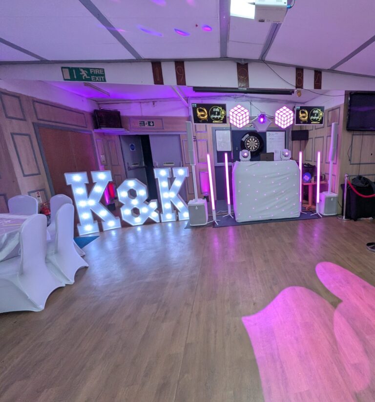 Custom K&K initial light-up letters with white starlit DJ booth at a Disctilldawn event