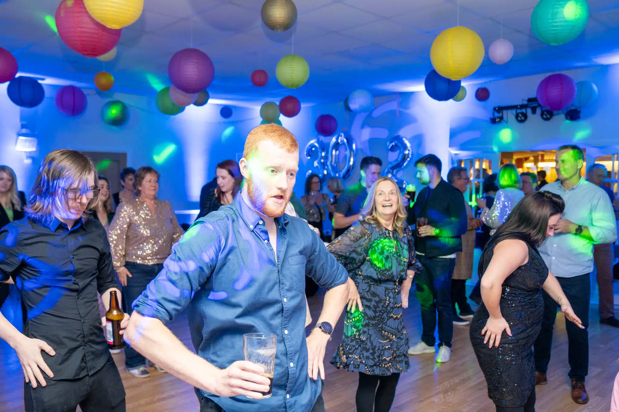 Guests enjoying a lively 13th birthday disco in a barn venue