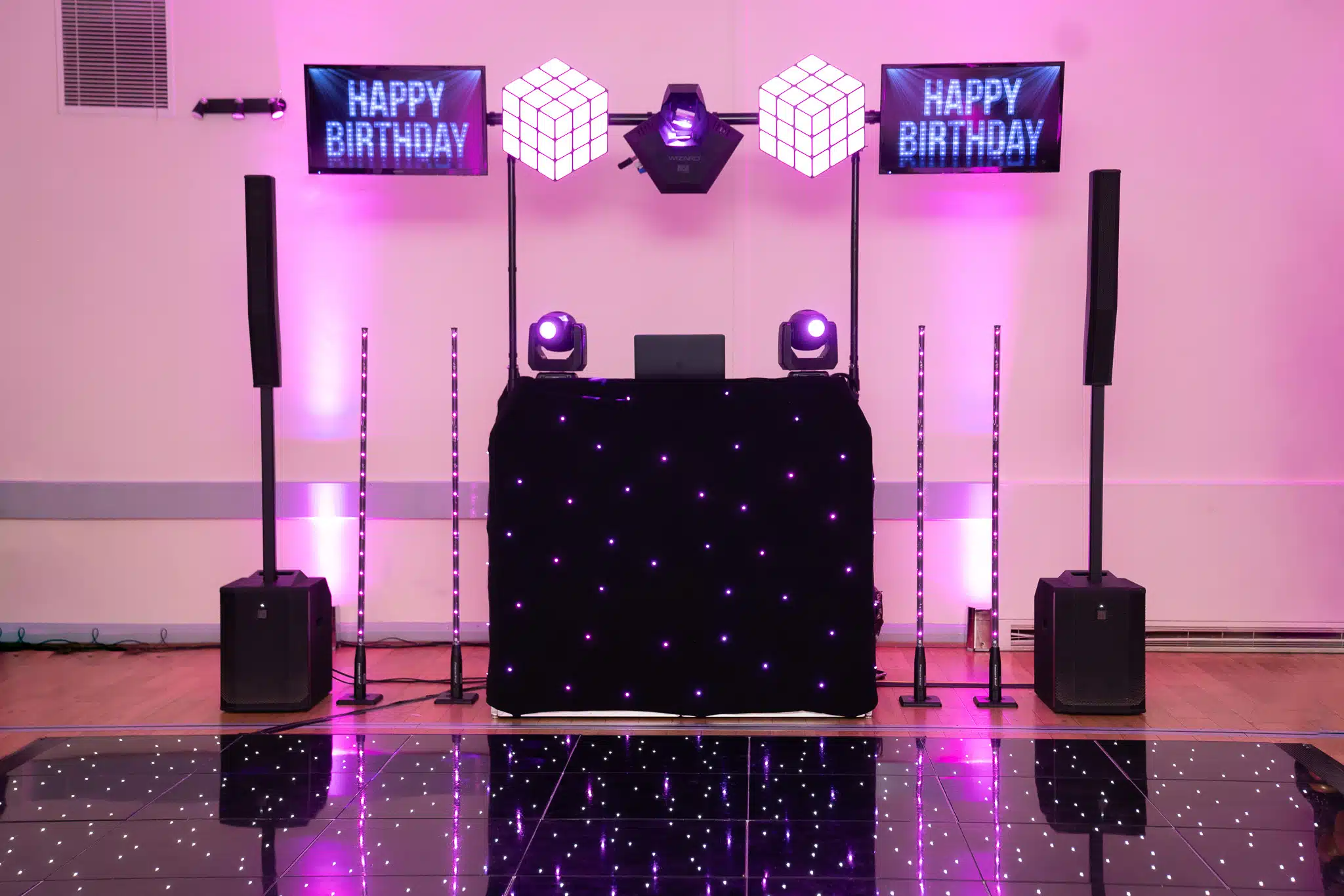 Premium black starlit DJ booth with pink uplighting