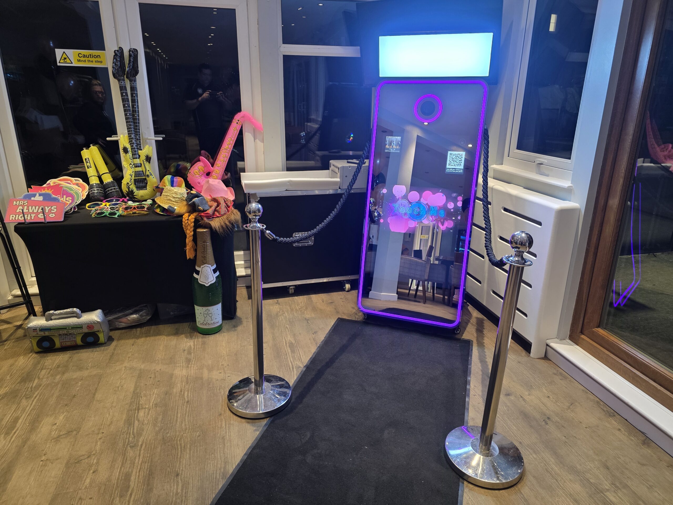 Disctilldawn Magic Mirror photo booth with props table and ropes barrier