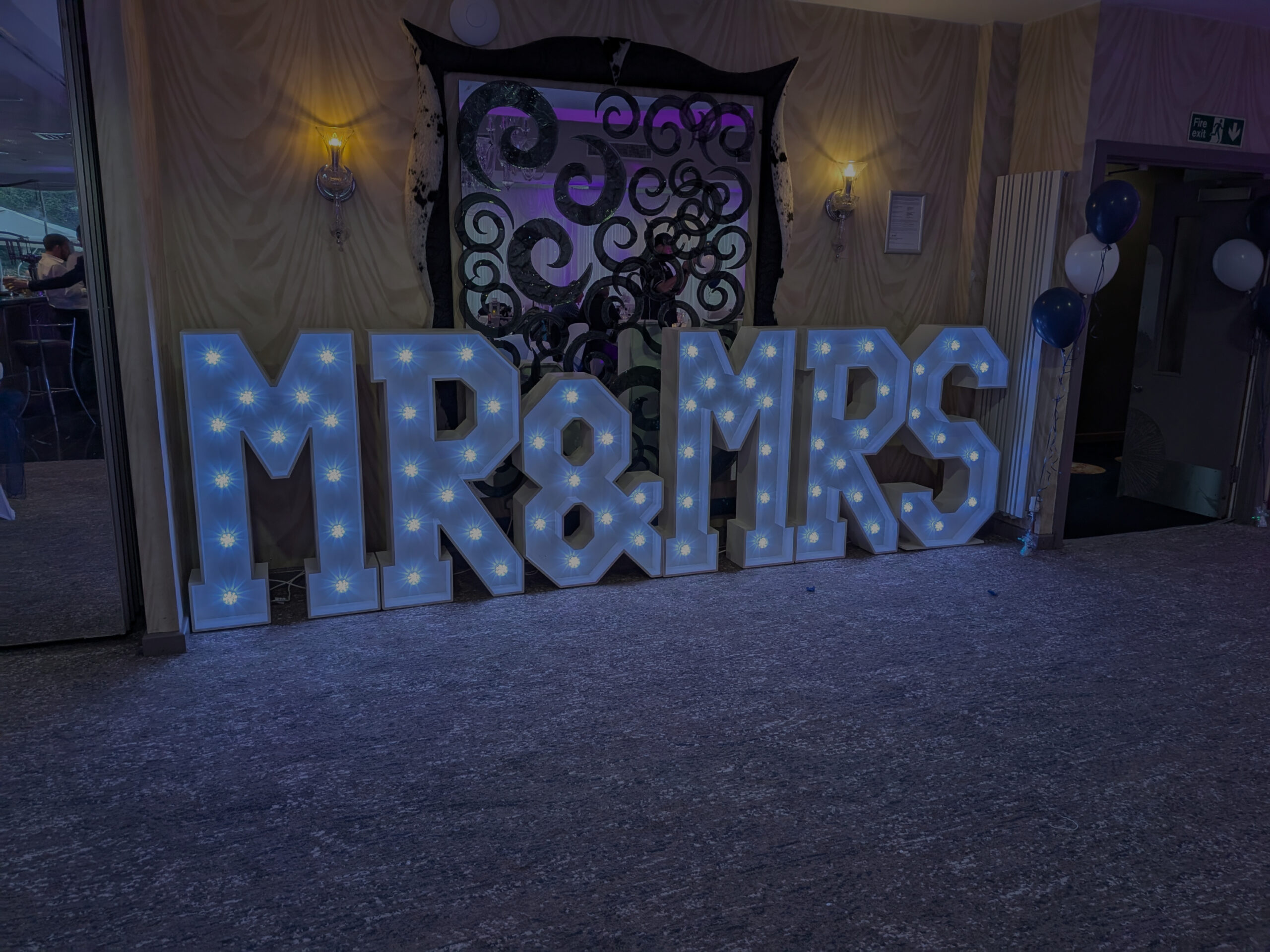 Disctilldawn Events team setting up a wedding disco rig with starlit DJ booth