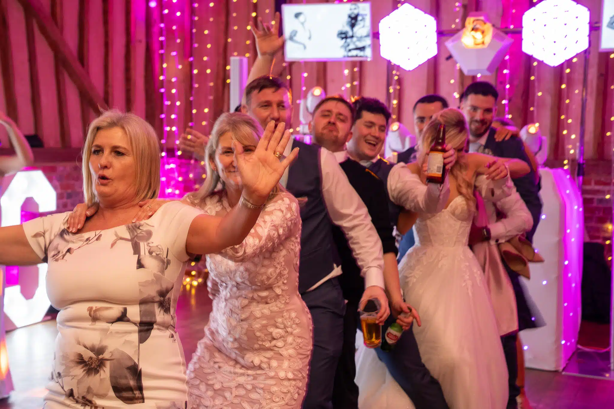 Magic Mirror photo booth at a wedding with pink uplighting