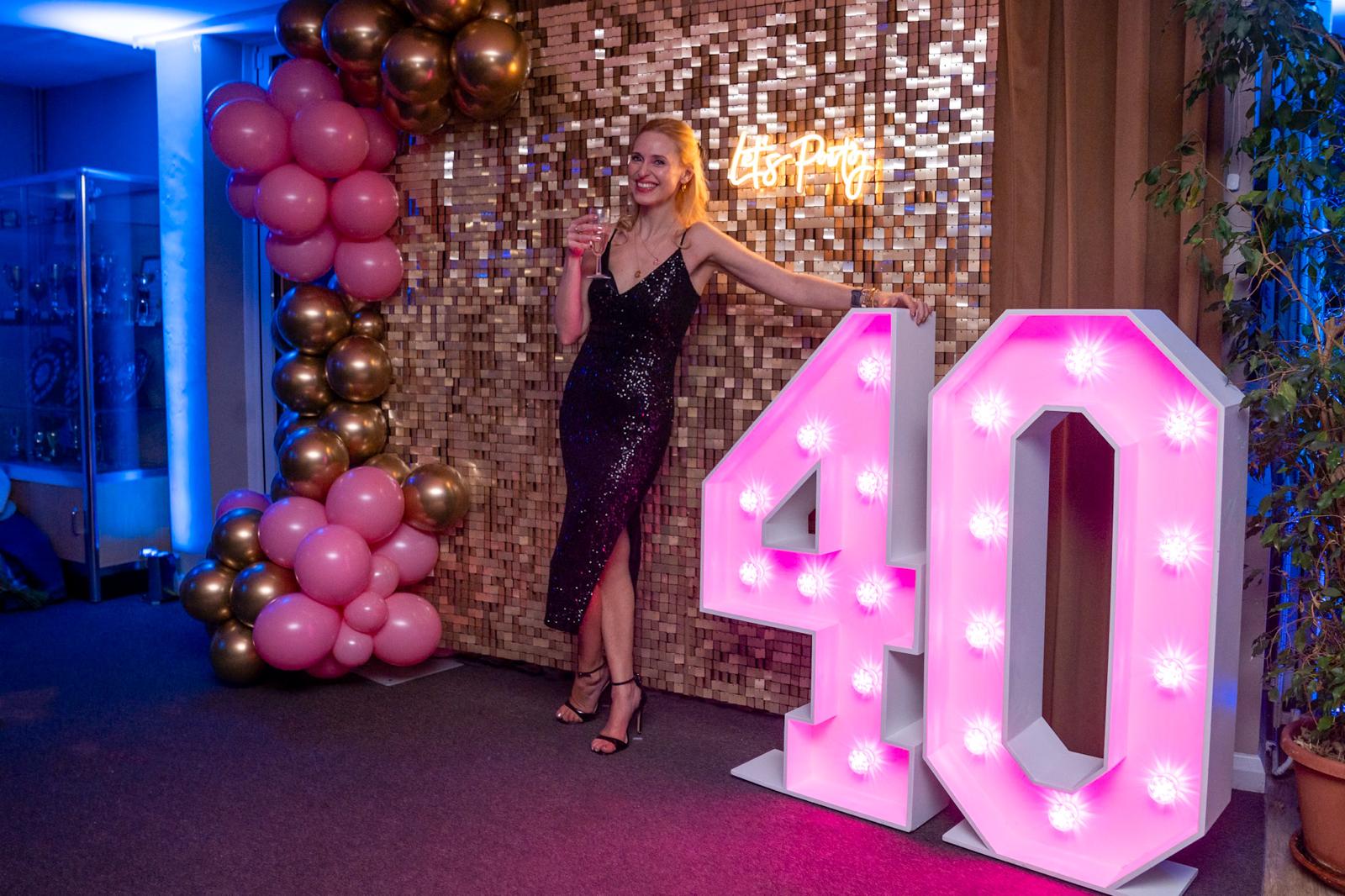 Sequin wall backdrop with soft lighting for a wedding or event venue
