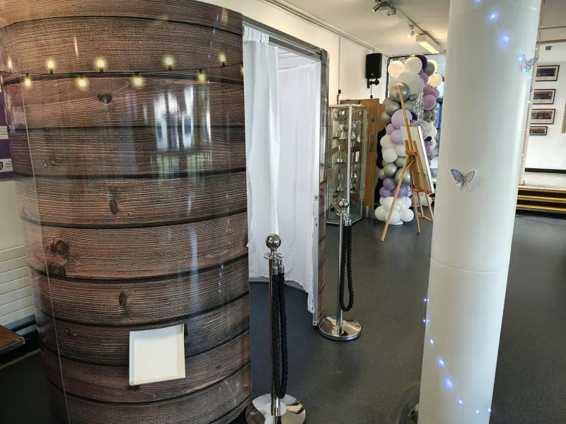 Classic enclosed photo booth in rustic wooden finish at an event