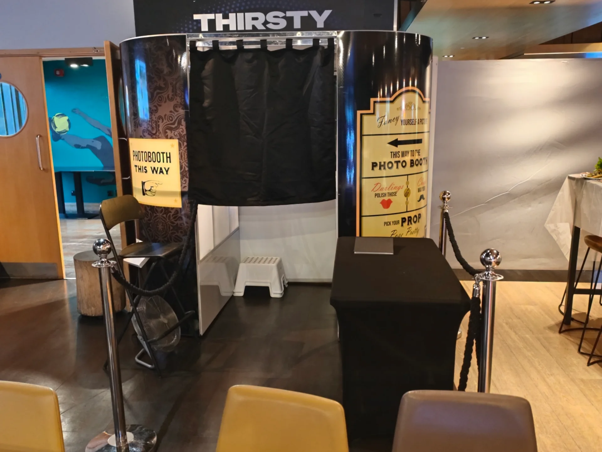 Classic enclosed Photo Booth with black curtains and a roped entrance at Goals Ruislip