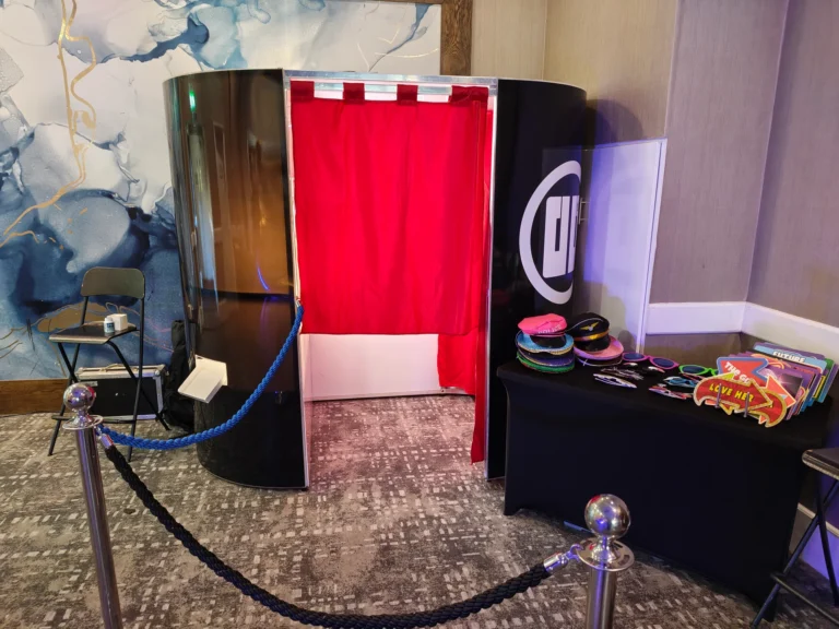 Classic Photo Booth with a red curtain and props table at Hilton London Watford for a prom